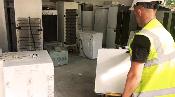 a howarth recycling expert picking up and collecting sheffields appliances in high visual uniform and hard hat