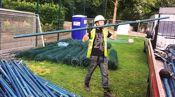 a howarths building site clearing expert clearing the last few building metal pipe items onto a scrap clearance truck