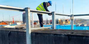 a large heating vent at a commercial site with a howarth expert dismantling it whilst assessing health and saftey before lifting the panels apart