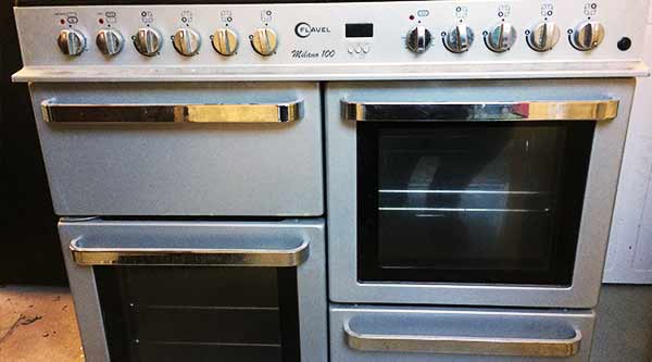 close up of a large 6 burner steel cooker for scrap showing the glass fronts of the double ovan and spacious top rings