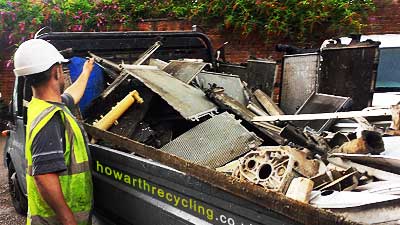 a howarth scrap metal collections expert dressed in high visability yellow on sheffield pick ups in our scrap metal removal vehicle