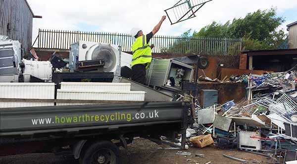 distance side front corner photo of a howarth recycling team member unloading a scrap metal collections truck of all the days scrap removed from sheffields homes and commercial premises