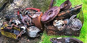 close up of old scrap metal tools and rails and floor grips with some angle iron and nuts and bolts and metal furniture from a home domestic garage for collection