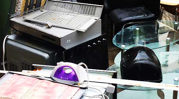 close up of various typical scrap electrical items including a kettle iron and toaster